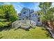 Backyard featuring a deck with astroturf, stairs, and a two-story home at 19075 E Grand Cir, Aurora, CO 80015