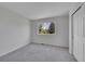 Bedroom with gray carpet, a window with green leafy view, and a closet with white doors at 19075 E Grand Cir, Aurora, CO 80015