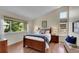Cozy bedroom features a comfortable bed, large window, and stylish decor at 19075 E Grand Cir, Aurora, CO 80015
