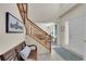 Inviting foyer with staircase, bench seating and a view into the Gathering room at 19075 E Grand Cir, Aurora, CO 80015