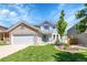 Charming two-story home featuring a well-maintained lawn and attached two-car garage at 19075 E Grand Cir, Aurora, CO 80015