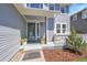 Welcoming covered front porch with decorative plants and seating area at 19075 E Grand Cir, Aurora, CO 80015