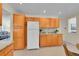 Bright kitchen showcasing wooden cabinets, light countertops, and stainless steel appliances at 19075 E Grand Cir, Aurora, CO 80015
