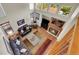 Aerial view of the living room showcasing soaring ceilings, a fireplace, and hardwood floors at 19075 E Grand Cir, Aurora, CO 80015