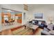 Open floor plan with living room flowing into kitchen and featuring hardwood floors and designer touches at 19075 E Grand Cir, Aurora, CO 80015