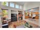 The living room showcases a fireplace and adjoins the kitchen with an eat in area, great for entertaining at 19075 E Grand Cir, Aurora, CO 80015
