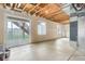 Unfinished basement with exposed ceiling beams and a sliding glass door leading to the backyard at 5546 Echo Hollow St, Castle Rock, CO 80104