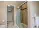 Bathroom with glass shower doors and tiled walls, alongside an open closet space with shelving for storage at 5546 Echo Hollow St, Castle Rock, CO 80104