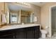 Bathroom featuring double sinks, granite countertops and a large mirror at 5546 Echo Hollow St, Castle Rock, CO 80104