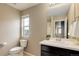 Bright bathroom featuring a well-lit vanity area and view of the outdoors through a window at 5546 Echo Hollow St, Castle Rock, CO 80104