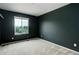 Cozy bedroom with a view of the outdoors through the window, set against dark-painted walls at 5546 Echo Hollow St, Castle Rock, CO 80104