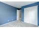 Bedroom with sliding closet doors offering convenient storage solutions, complemented by neutral carpeting at 5546 Echo Hollow St, Castle Rock, CO 80104