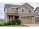 Two-story home with a two-car garage and beautifully landscaped front yard at 5546 Echo Hollow St, Castle Rock, CO 80104