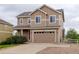 Two-story home with a two-car garage, complemented by a well-manicured lawn at 5546 Echo Hollow St, Castle Rock, CO 80104