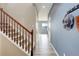 Bright hallway with hardwood floors, stairway, and stylish decor at 5546 Echo Hollow St, Castle Rock, CO 80104