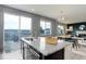 Kitchen island featuring granite countertops with stainless sink and large sliding doors to back deck at 5546 Echo Hollow St, Castle Rock, CO 80104