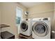 Laundry room with a modern washer and dryer set, plus convenient shelving above for storage at 5546 Echo Hollow St, Castle Rock, CO 80104