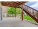 The covered concrete patio features wooden supports and stairs to a lush backyard at 5546 Echo Hollow St, Castle Rock, CO 80104
