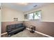 Basement featuring a black futon, a small table, and wall decor at 7331 S Webster St, Littleton, CO 80128