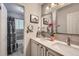 Bathroom featuring double sinks, marble countertop, and decorative mirrors at 7331 S Webster St, Littleton, CO 80128