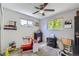 Bright bedroom featuring multiple windows and toys at 7331 S Webster St, Littleton, CO 80128