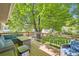 Outdoor deck with wooden railings, comfortable seating, and shade tree at 7331 S Webster St, Littleton, CO 80128
