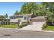 Traditional two-story home with well-manicured lawn, mature trees, and an attached garage at 7331 S Webster St, Littleton, CO 80128