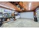 Oversized garage featuring wooden rafters and abundant workspace and storage at 7331 S Webster St, Littleton, CO 80128