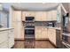 Well-lit kitchen showcasing wooden cabinets, stainless steel appliances, and a tiled backsplash at 7331 S Webster St, Littleton, CO 80128