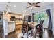 Eat in kitchen with a dining table, stainless steel appliances, hardwood floors, and plenty of natural light at 7331 S Webster St, Littleton, CO 80128
