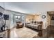Comfortable living room with a bay window, plush seating, fireplace, and hardwood floors at 7331 S Webster St, Littleton, CO 80128