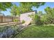 Backyard shed and garden area bordered by plants and flowers at 7331 S Webster St, Littleton, CO 80128