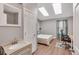 Light-filled bedroom with skylights, a modern desk, and an attached bathroom for convenience at 9240 W Ontario Dr, Littleton, CO 80128