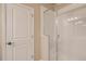 Bright bathroom featuring white-tiled shower with glass door and neutral walls at 6817 Huddersfield Ln, Castle Pines, CO 80108