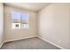 A bright bedroom with a window and neutral carpet, ready for personalization at 6817 Huddersfield Ln, Castle Pines, CO 80108