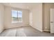 A bright bedroom features neutral walls, plush carpet, and a window providing natural light at 6817 Huddersfield Ln, Castle Pines, CO 80108