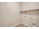 The laundry room features wood-style floors and a shelf at 6817 Huddersfield Ln, Castle Pines, CO 80108