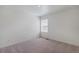 Neutral bedroom with carpeted floors, a single window, and electrical outlets visible at 4757 Windmill Dr, Brighton, CO 80601