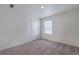 Neutral bedroom with carpeted floors, a single window, and an electrical outlet visible at 4757 Windmill Dr, Brighton, CO 80601
