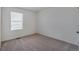 Neutral bedroom with carpeted floors, a single window, and an electrical outlet visible at 4757 Windmill Dr, Brighton, CO 80601