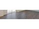 Close-up on modern wood-look floors, white walls, and sliding glass door at 4757 Windmill Dr, Brighton, CO 80601