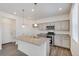 Well-equipped kitchen with gray cabinets, stainless steel appliances, and a large island perfect for entertaining at 4757 Windmill Dr, Brighton, CO 80601