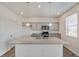 Kitchen island with speckled granite countertops and stainless steel sink, accented by pendant lighting at 4757 Windmill Dr, Brighton, CO 80601