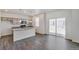Bright, open-concept kitchen features gray cabinets, stainless steel appliances, and a large island with stone countertops at 4757 Windmill Dr, Brighton, CO 80601