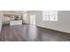 Open-concept living area with wood-look floors, white walls, and abundant natural light at 4757 Windmill Dr, Brighton, CO 80601