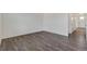 Bright living room with wood-look flooring, white walls, and plenty of space at 4757 Windmill Dr, Brighton, CO 80601