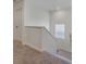Neutral stairway with carpeted steps and white banister leading to the upper level at 4757 Windmill Dr, Brighton, CO 80601