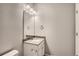 This bathroom features a white vanity, mirror, lighting and gray walls at 6882 Huddersfield Ln, Castle Pines, CO 80108