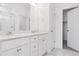 Bathroom with double sink vanity, marble floors and shower with glass door at 6882 Huddersfield Ln, Castle Pines, CO 80108
