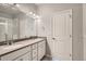 Bright bathroom features dual sinks, a large mirror, and a walk-in shower at 6882 Huddersfield Ln, Castle Pines, CO 80108